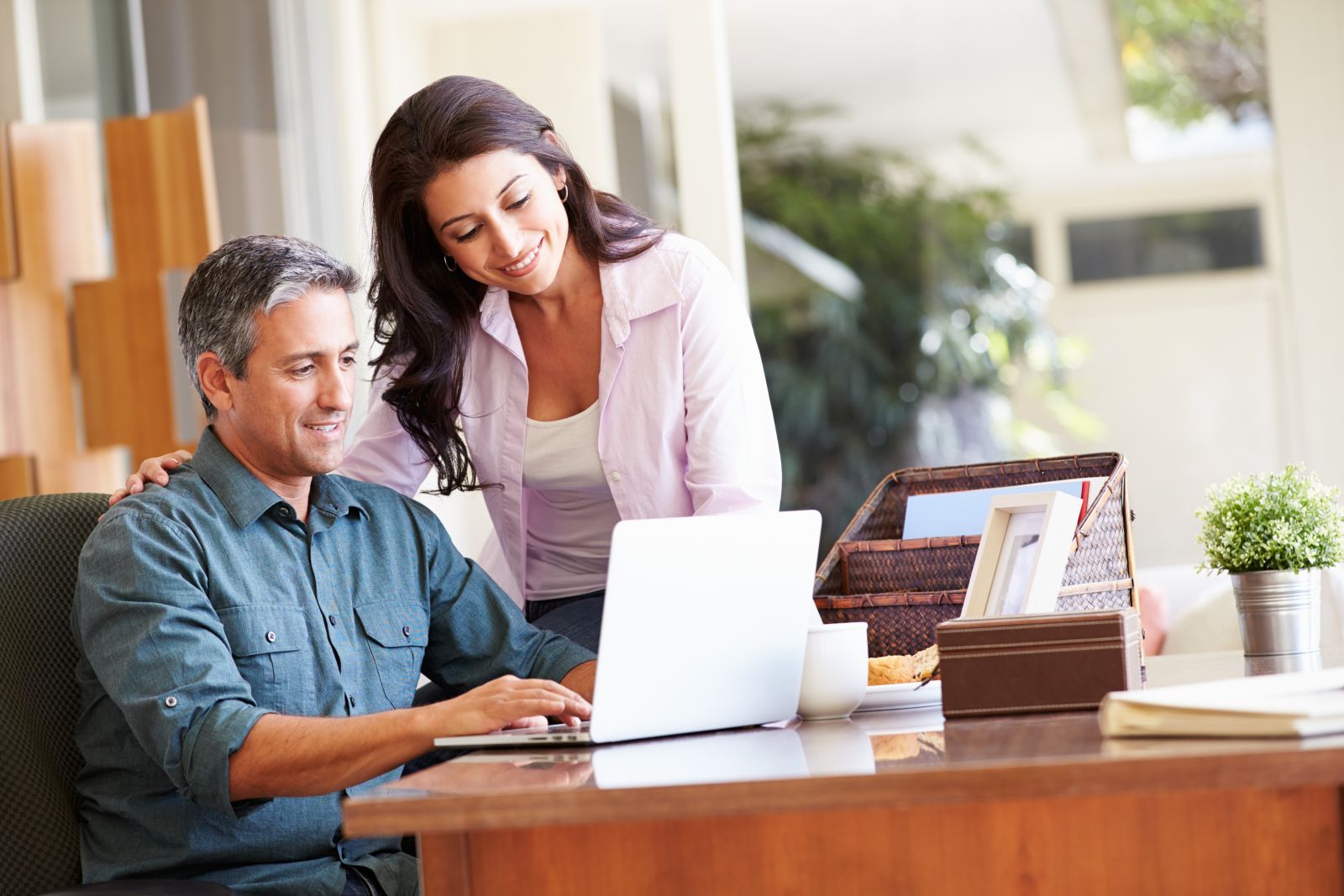 happy couple looking at computer
